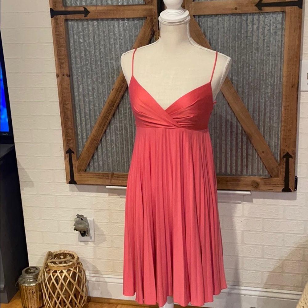 Coral satin strapless dress with pleated skirt